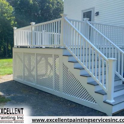 A white deck with stairs and a railing by excellent painting inc.