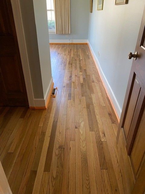 a hallway with hardwood floors and a door in a house 