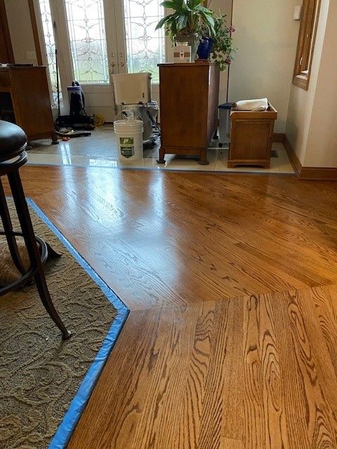 a living room with hardwood floors and a rug 
