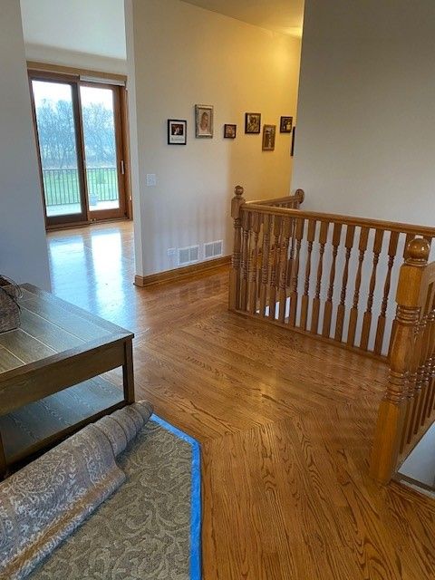 a living room with hardwood floors and a staircase