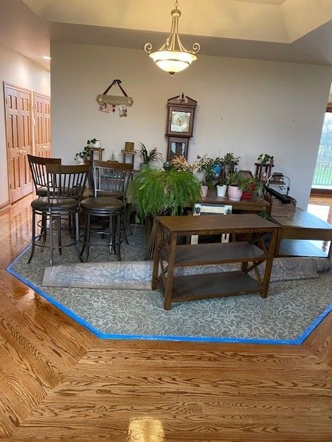 a living room with hardwood floors and a clock on the wall