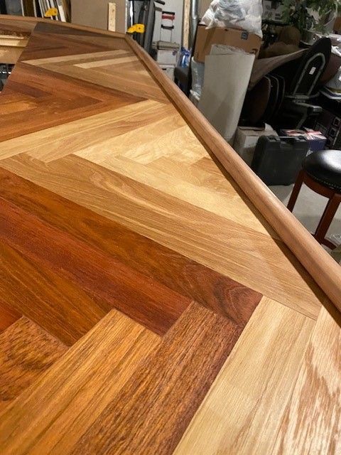 a close-up of a wooden floor with a herringbone pattern