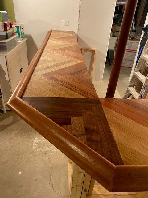 a wooden bar with a chevron pattern is sitting in a room 