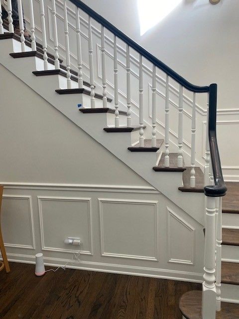 a staircase with white railings and wooden steps