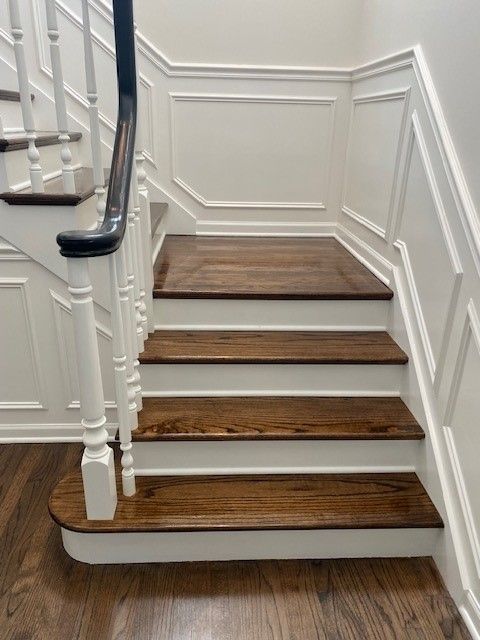 a staircase with wooden steps and a white railing