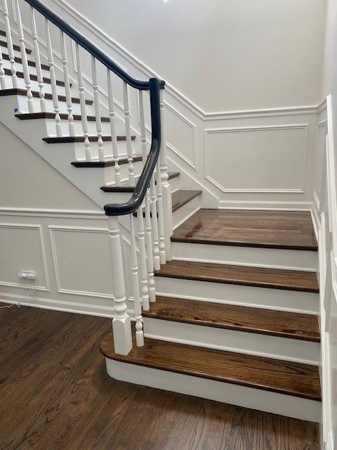 a staircase with white railings and wooden steps