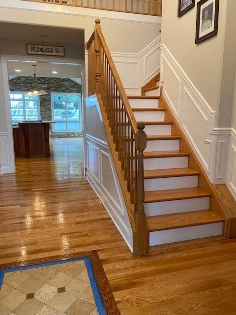 a wooden staircase with white steps in a house