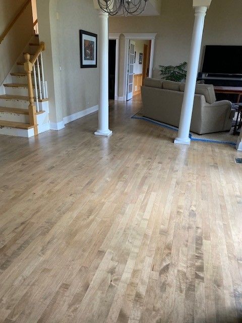 a living room with hardwood floors and stairs