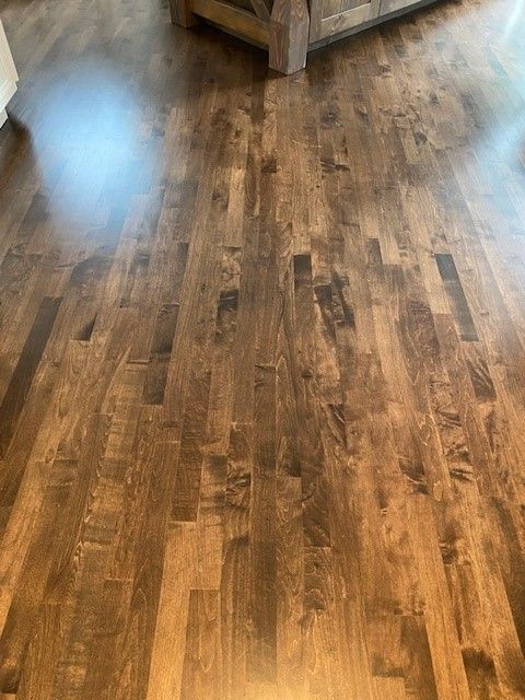 a living room with hardwood floors and a couch.