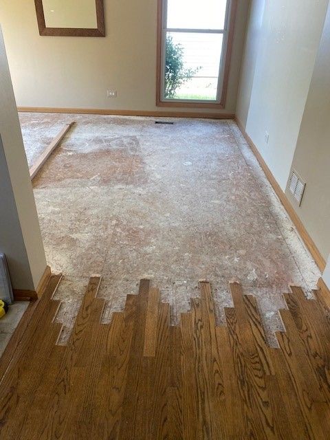a living room with hardwood floors and a window.