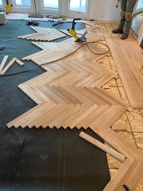 a wooden floor is being installed in a herringbone pattern