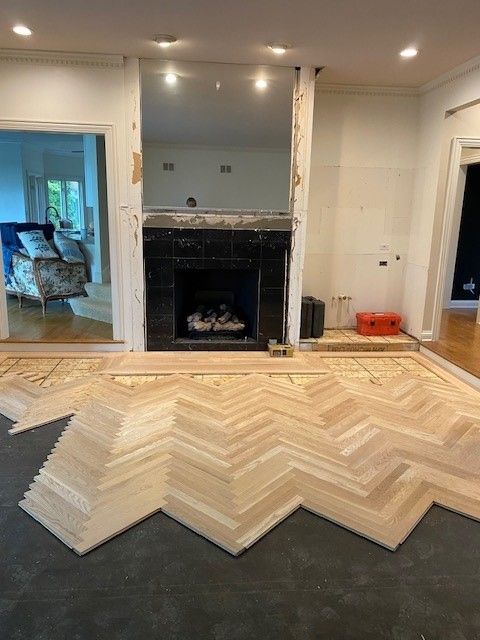 a living room with a fireplace and a wooden floor.