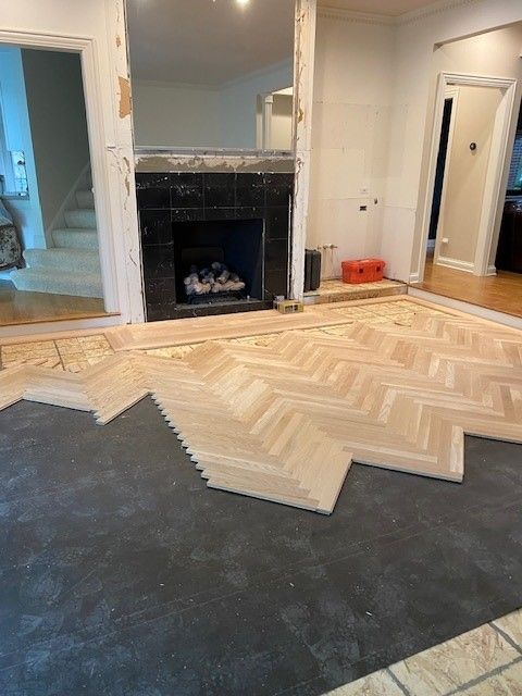 a living room with a fireplace and a wooden floor