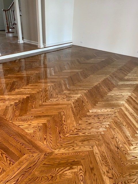 a wooden floor with a herringbone pattern in the living room