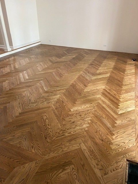a wooden floor with a herringbone pattern in a room.