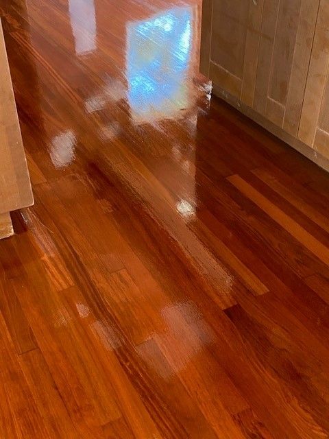 a close-up of a wooden floor in a kitchen.