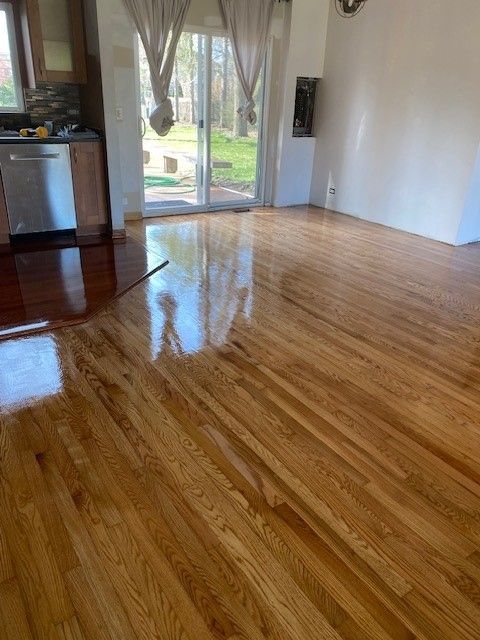 a living room with hardwood floors and a sliding glass door.
