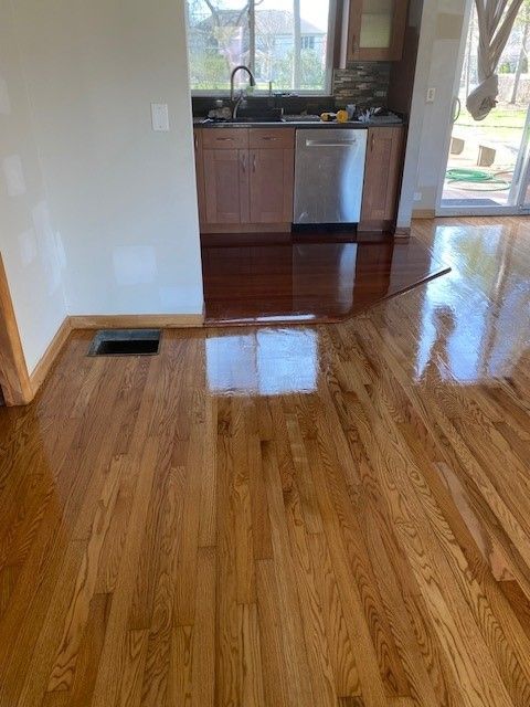 a kitchen with hardwood floors and a stainless steel dishwasher.