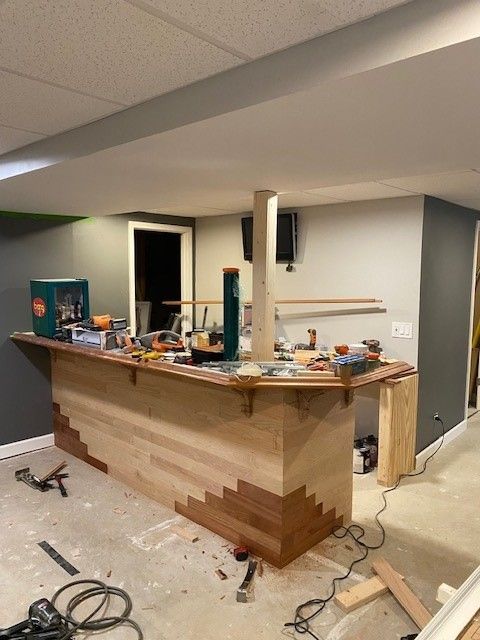a wooden bar is being built in a basement