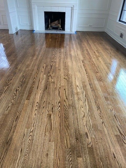 a room with hardwood floors and a fireplace.