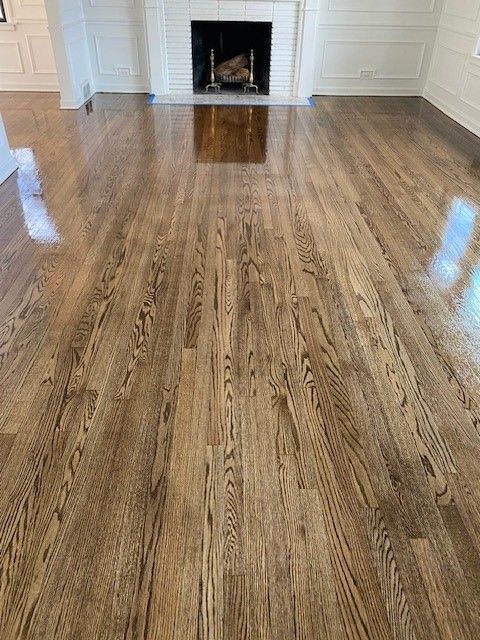 a living room with hardwood floors and a fireplace