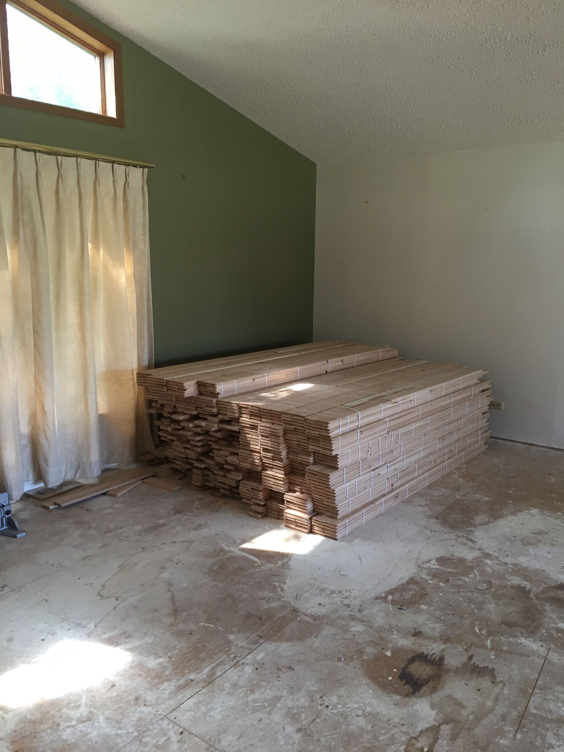a room with a lot of wood in it and a window 