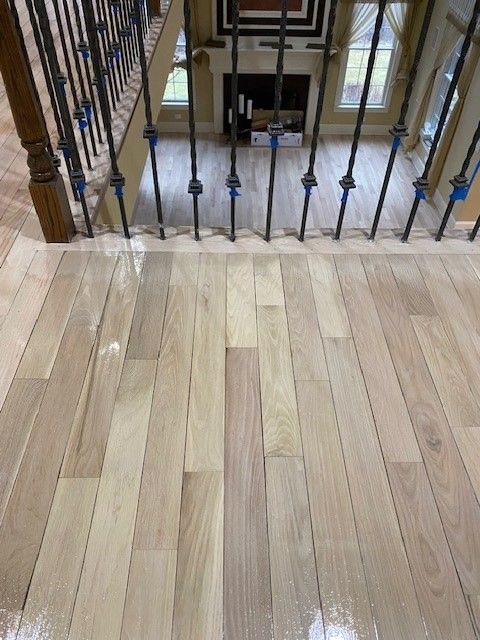 a wooden floor with a metal railing in a living room 