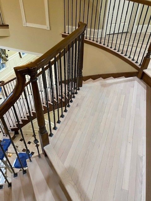 a wooden staircase with a metal railing in a house