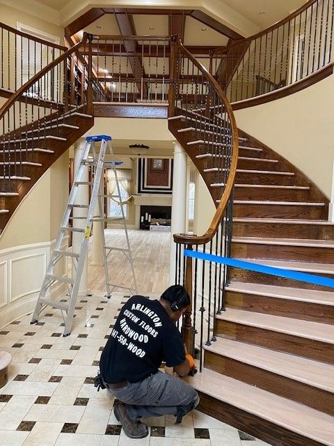 a man wearing a shirt that says volunteer is working on a staircase