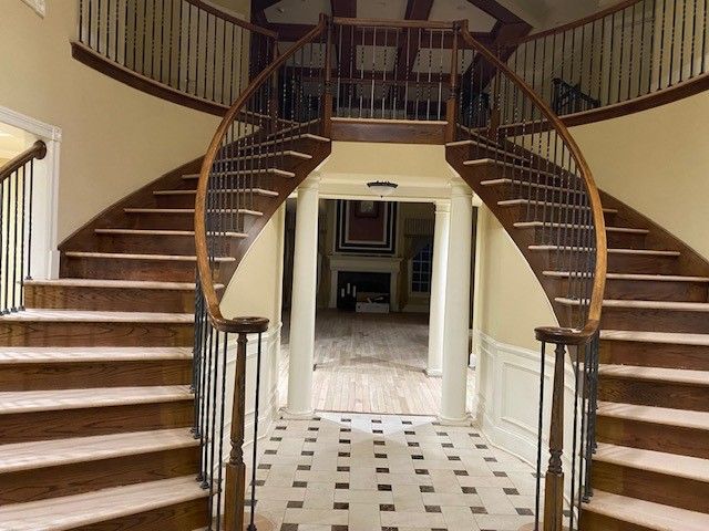 a spiral staircase leading up to the second floor of a house