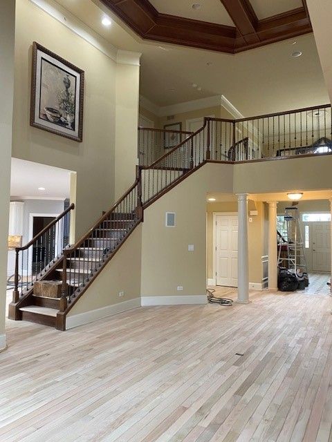 a staircase in a house with a picture on the wall above it