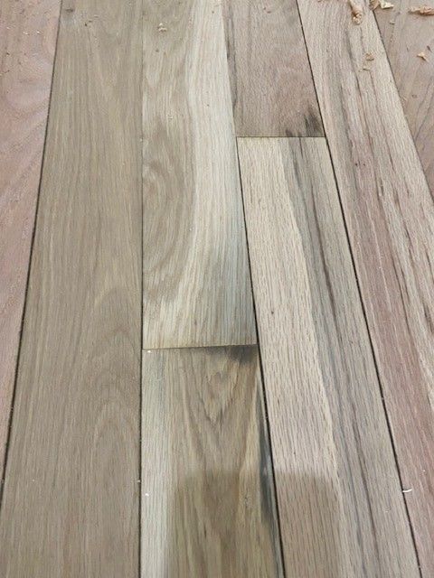 a close-up of a piece of wood on a wooden floor.