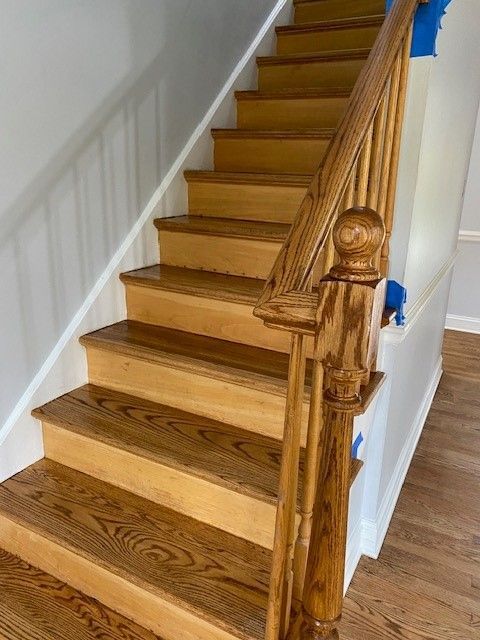 a wooden staircase with wooden steps and a wooden railing in a house