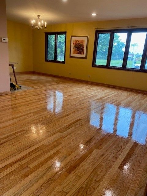 a living room with hardwood floors and yellow walls