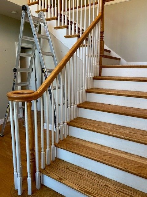 a ladder is sitting on top of a wooden staircase