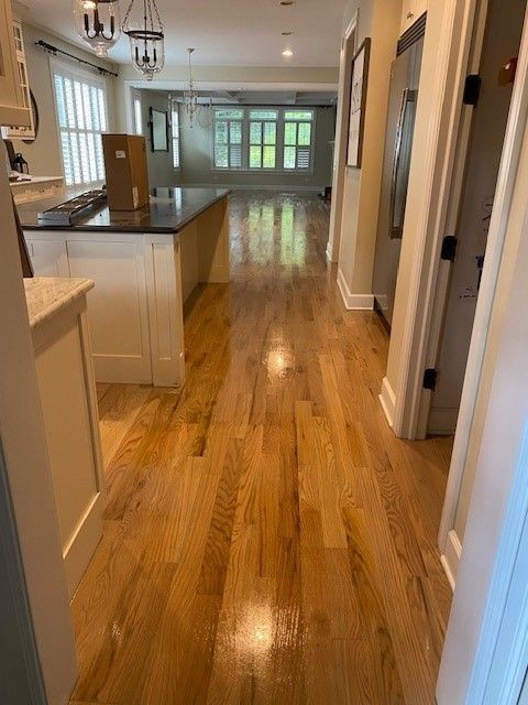 a kitchen with hardwood floors and a large island.