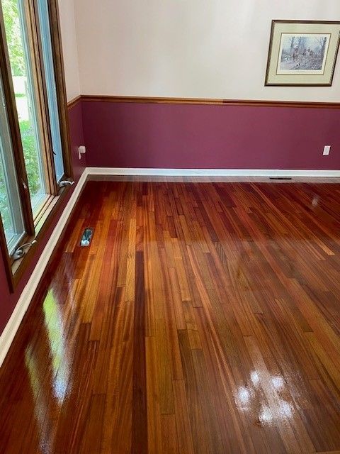a living room with hardwood floors and purple walls 