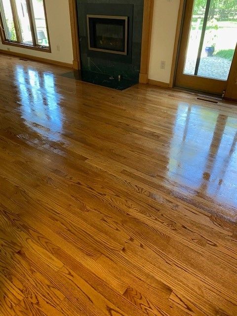 a living room with hardwood floors and a fireplace 