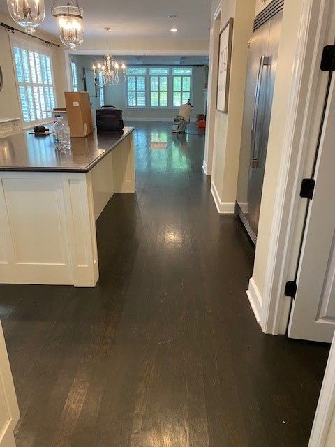a kitchen with a large island and a stainless steel refrigerator.