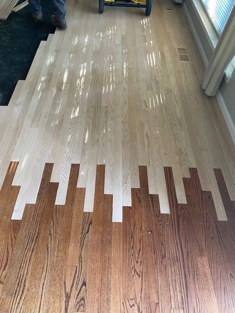 a wooden floor with a pattern of white stripes on it.
