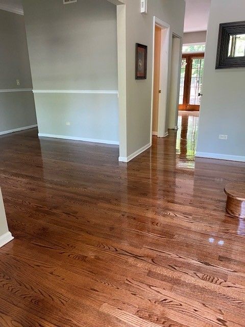 a living room with hardwood floors and a staircase.