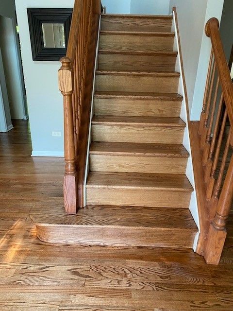 a wooden staircase with a wooden railing in a house.