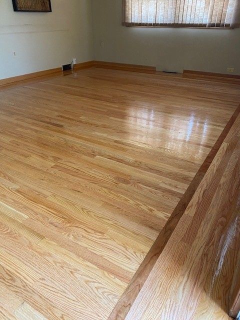 a living room with hardwood floors and a window.