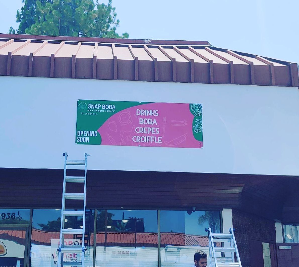 A sign on the side of a building advertises drinks