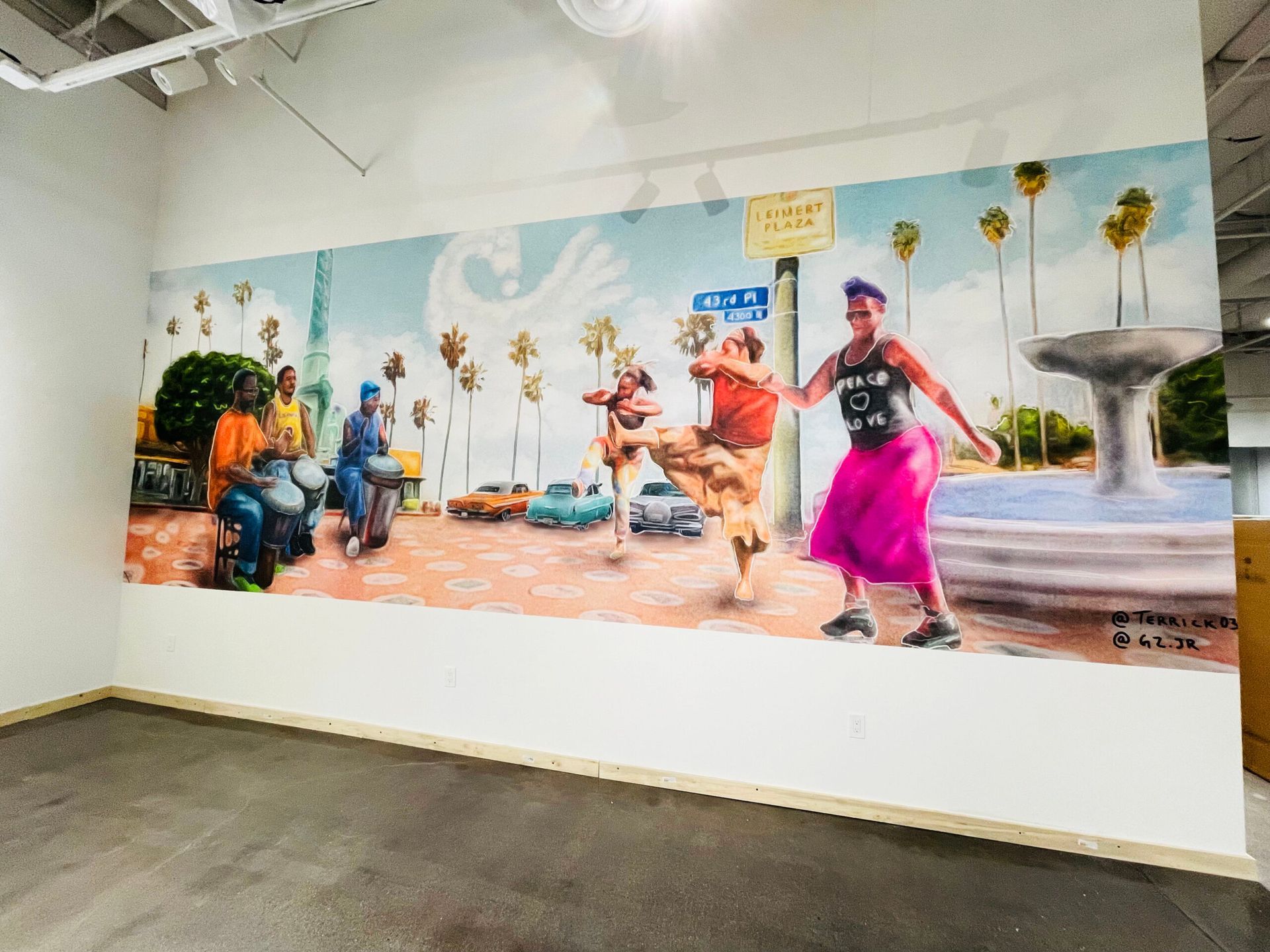 A large painting of a woman in a pink skirt is on a wall in a room.