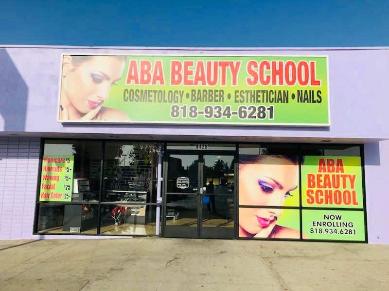 A purple building with a green sign that says aba beauty school