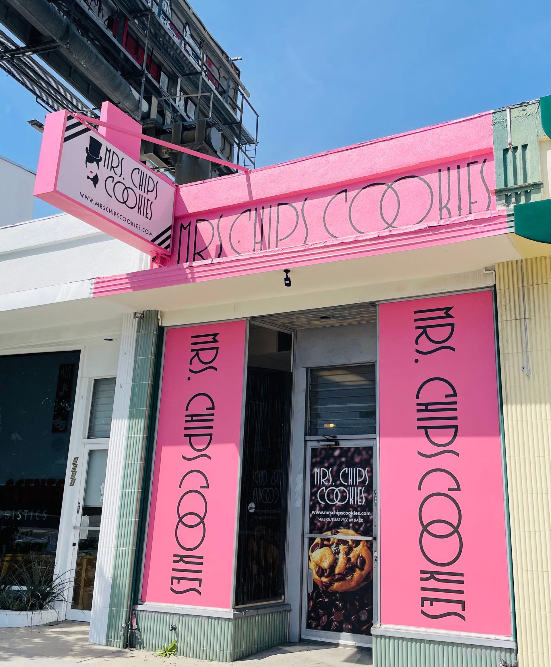 A pink building with a sign that says mrs chips cookies