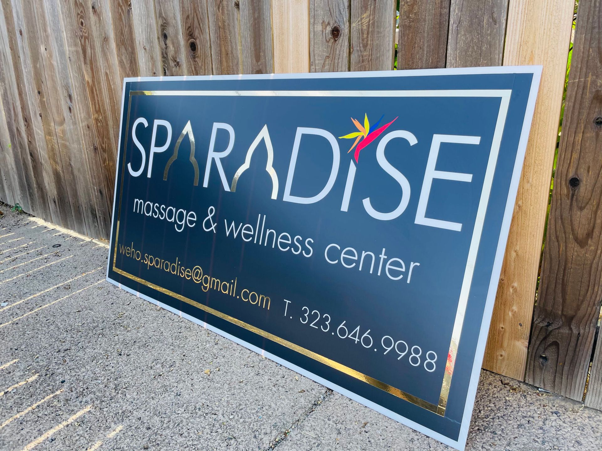 A large sign for paradise massage and wellness center
