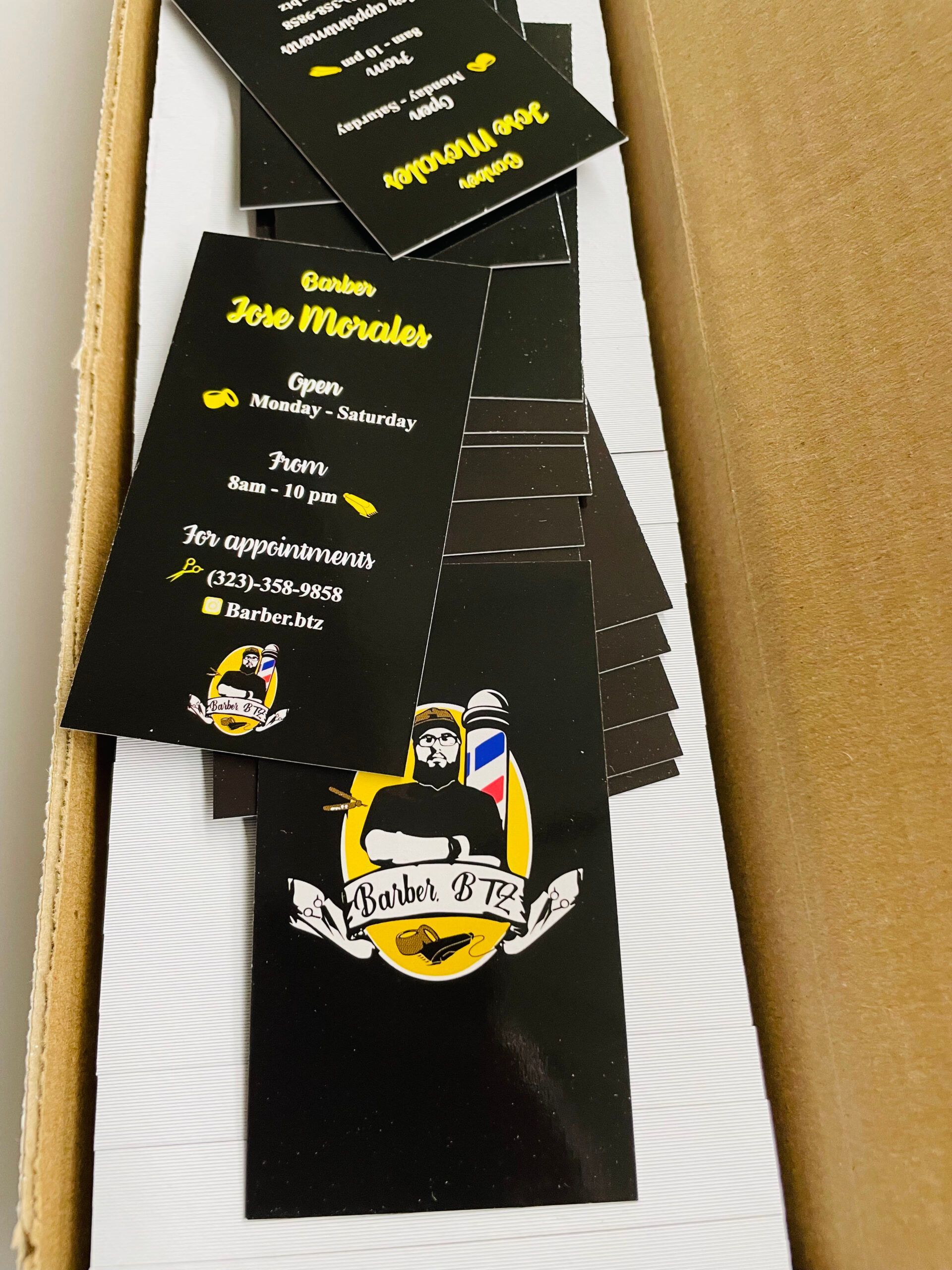 A box of business cards for jose morales barber shop