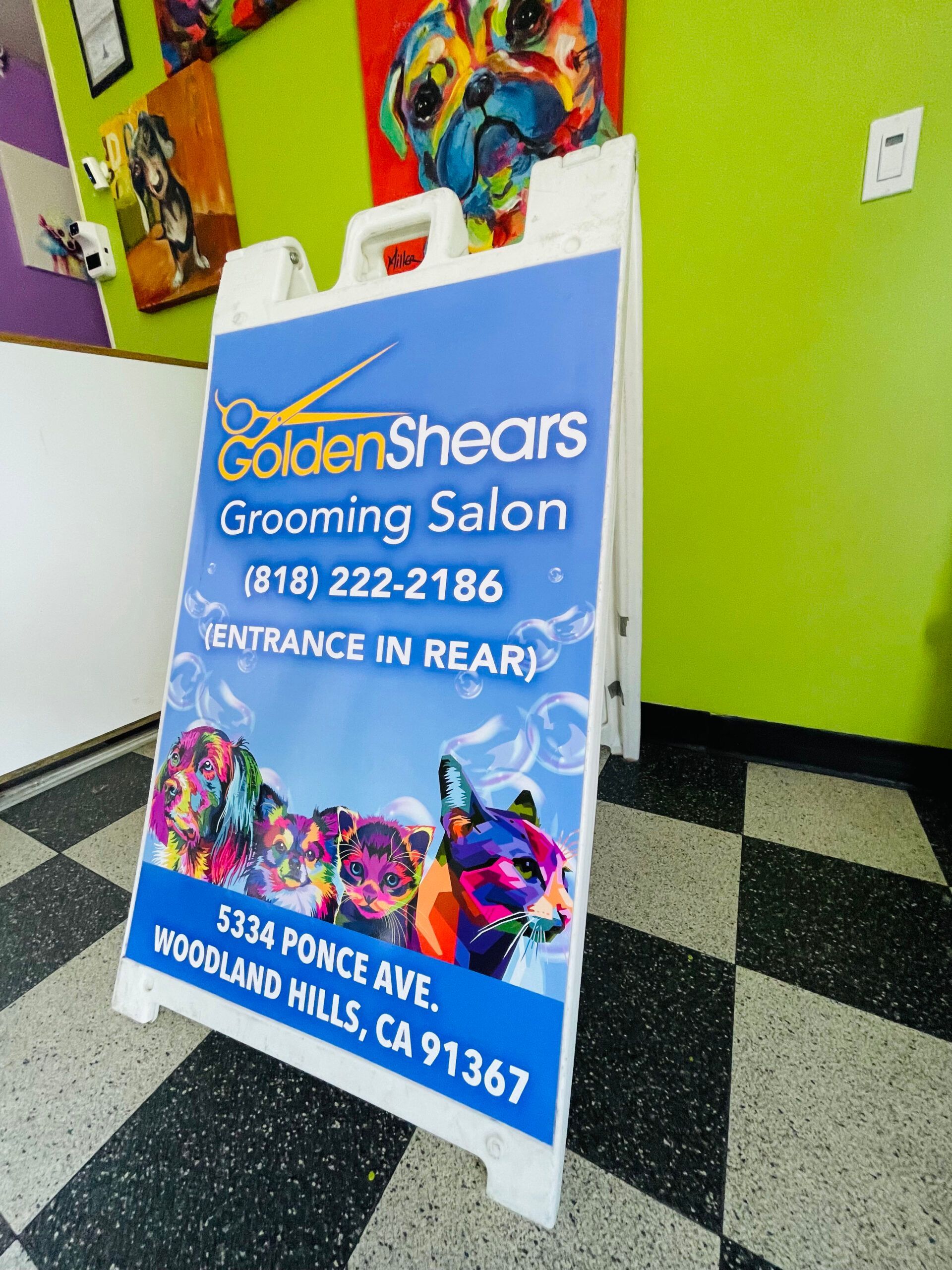 A sign for golden shears grooming salon in woodland hills ca